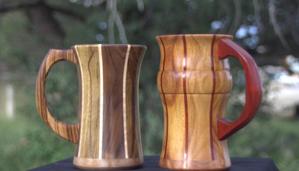 Peruvian Walnut, Black Limba and Maple mugs beside a Canary mug with Paduak stripes